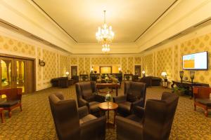 a hotel lobby with chairs and a television at Vesta Bikaner Palace in Bikaner