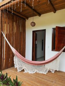 a hammock in the middle of a room at Pousada Aconchego in Caraíva