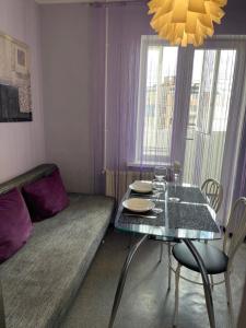 a room with a table and a bed and a table and chairs at 5й Зарічній 44 in Kryvyi Rih