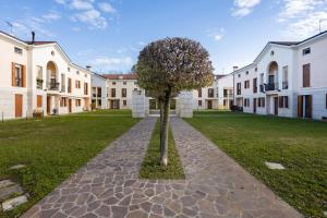 a tree in the middle of a courtyard at PARCO ROMY - Free Parking con giardino in Limena