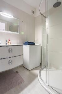 a white bathroom with a shower and a sink at PARCO ROMY - Free Parking con giardino in Limena