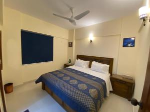 a bedroom with a bed and a large television at 3 Bed Apartment in Karachi