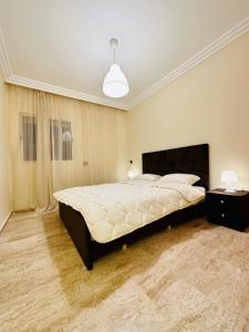 a bedroom with a large bed in a room at Apartement sur la corniche, vue sur mer in Rabat