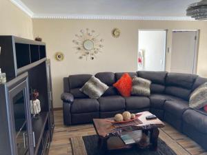 a living room with a couch and a table at Elim self catering in Fisherhaven