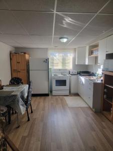 a kitchen with white appliances and a table in it at Saugeen Shores Vacation Rental in Port Elgin
