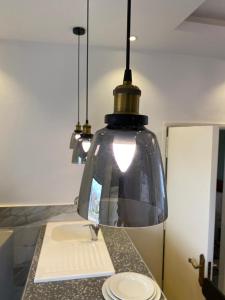 aendant light hanging over a sink in a kitchen at Sôsuite in Saly Portudal