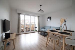 a living room with a table and a dining room at Appartement de charme au cœur de Marseille in Marseille