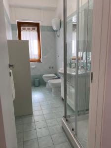a bathroom with a shower and a toilet and a sink at Casa Marinella in Vico Equense
