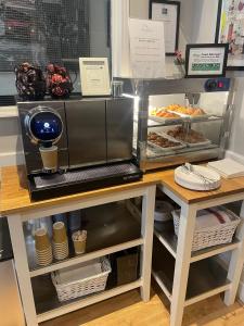 a bakery with a counter with food on it at The Melita in London