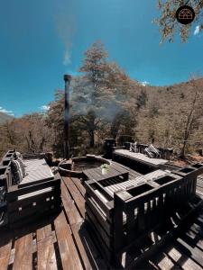 a wooden deck with a view of a mountain at Black Domes in Nevados de Chillan