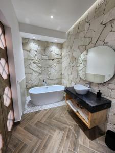 a large bathroom with a tub and a sink at Hotel Úrsula Concept in Querétaro +18 photos