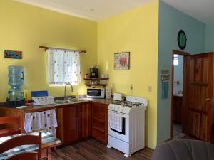 a kitchen with a white stove top oven in a room at Lily Pad II in Caye Caulker