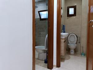 a bathroom with a toilet and a sink at Luxury Family House with Garden View Casablanca in Casablanca