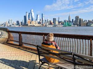 a person sitting on a bench looking at the city at TRANQUIL TOWN HOUSE IN NEW JERSEY - JUST 25 MINUTES To TIME SQUARE! in Jersey City