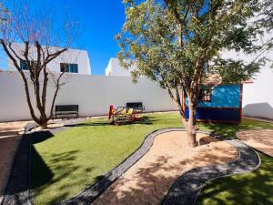 a park with two trees and a bench in a yard at Casa SOL #222, para 6 personas in La Paz