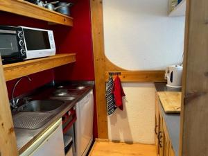 a small kitchen with a sink and a microwave at Studio Les Arcs 2000, 1 pièce, 4 personnes - FR-1-346-545 in Arc 2000
