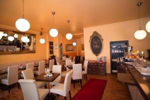 a restaurant with white chairs and tables and a mirror at City Guesthouse Pension Berlin in Berlin +39 photos