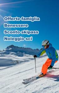 a person is skiing down a snow covered slope at A L'Aquila per un sogno in LʼAquila