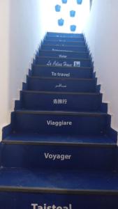 a set of blue stairs with the words vogelridevertisementsvertisementsvertisements at La colina House taghazout in Taghazout