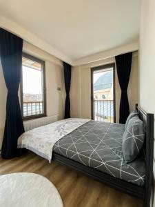 a bedroom with a bed and two windows at Luxury home in Istanbul's Golden Horn in Istanbul