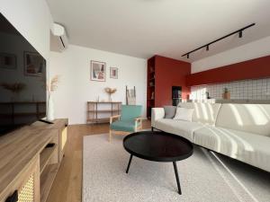 een woonkamer met een bank en een tafel bij Klingerka brand new 1-bedroom apartment free parking in Nivy