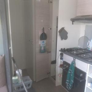 a small kitchen with a stove and a sink at Domaine in Litteau