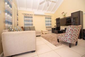 a living room with a couch and a chair at Richmond Estate With Pool House in Ocho Rios