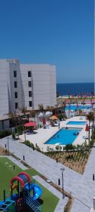 a resort with a playground and a swimming pool at شاليه للايجار اليومى بورتو سعيد in Port Said