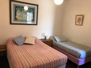 a room with two beds and a picture on the wall at Hotel Rid in Mar del Plata