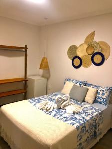 een slaapkamer met een bed met blauwe en witte lakens bij Pousada Ventos da Barra in Barra de Santo Antônio