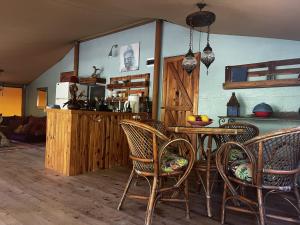a kitchen with a table and chairs in a room at Campo Portakal Eco Glamping in Cıralı