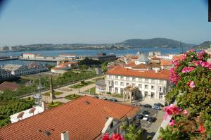 a view of a city with buildings and flowers at Parador de Ferrol in Ferrol