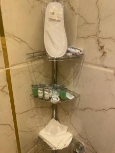 a shelf in a bathroom with a mirror and toiletries at مساكن ميرنا in Taif