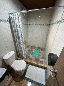 a bathroom with a toilet and a shower at Bonanza in Monteverde Costa Rica