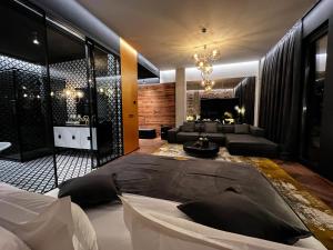 a bedroom with a bed and a living room at Mandarin Club House in Batumi