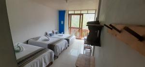 a room with two beds and a window at Gocta Mirador in Cocachimba