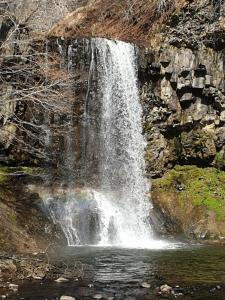 a waterfall on the side of a rock wall at sas Road Runner Café in Égliseneuve-dʼEntraigues