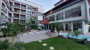 a building with a swimming pool next to a building at Modern 1-bed Seaside Flat Bijilo in Sere Kunda