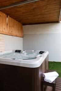a jacuzzi tub sitting in the middle of a yard at O&O Group - Huge Villa With Jacuzzi By The Beach in Rishon LeẔiyyon