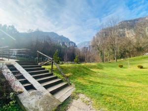 a set of stairs in a field with mountains at Vila Vanilla in Donji Striževac