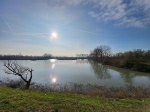 a view of a lake with the moon in the sky at Alloggio indipendente Cesulìn in Porto Viro