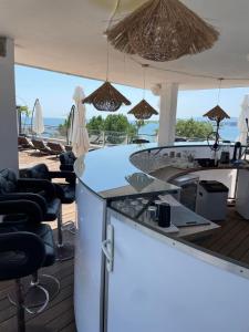 a bar with chairs and a view of the ocean at Deluxe Apartments Приморско in Primorsko