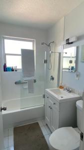 a bathroom with a shower and a sink and a toilet at Hollywood Beach and Boardwalk in Hollywood