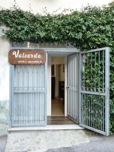 an entrance to a villa with a gate and vines at Valverde in Cengio