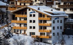 a building with snow on top of it at Alkira in Sankt Anton am Arlberg
