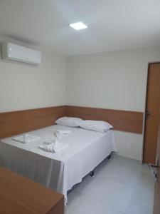 Ένα ή περισσότερα κρεβάτια σε δωμάτιο στο Pousada Tambaú Praia