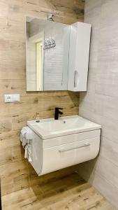 a bathroom with a white sink and a mirror at Вілла Aqua Shayan in Shaian +55 photos