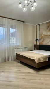 a bedroom with a large bed and a large window at Вілла Aqua Shayan in Shaian
