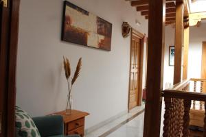 a living room with a chair and a vase on a table at Hotel La Zubia , Granada in La Zubia