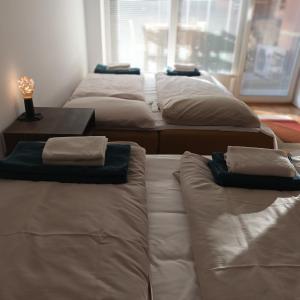 a group of four mattresses in a room with a table at Grand Hippy Twist in Moravske-Toplice